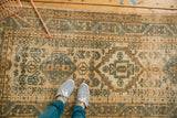 Geometric border and field patterns in muted teal, earthy brown on a vintage Karaja runner.