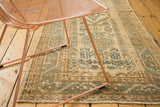 Geometric tribal pattern on a hand-knotted vintage runner in earth tones and teal.