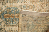 Detail of vintage Karaja rug showing beige, blue, brown geometric pile and hand-knotted foundation.