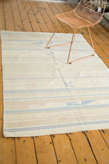 Southwestern striped pattern on a vintage Dhurrie rug in ivory, green, and blue.