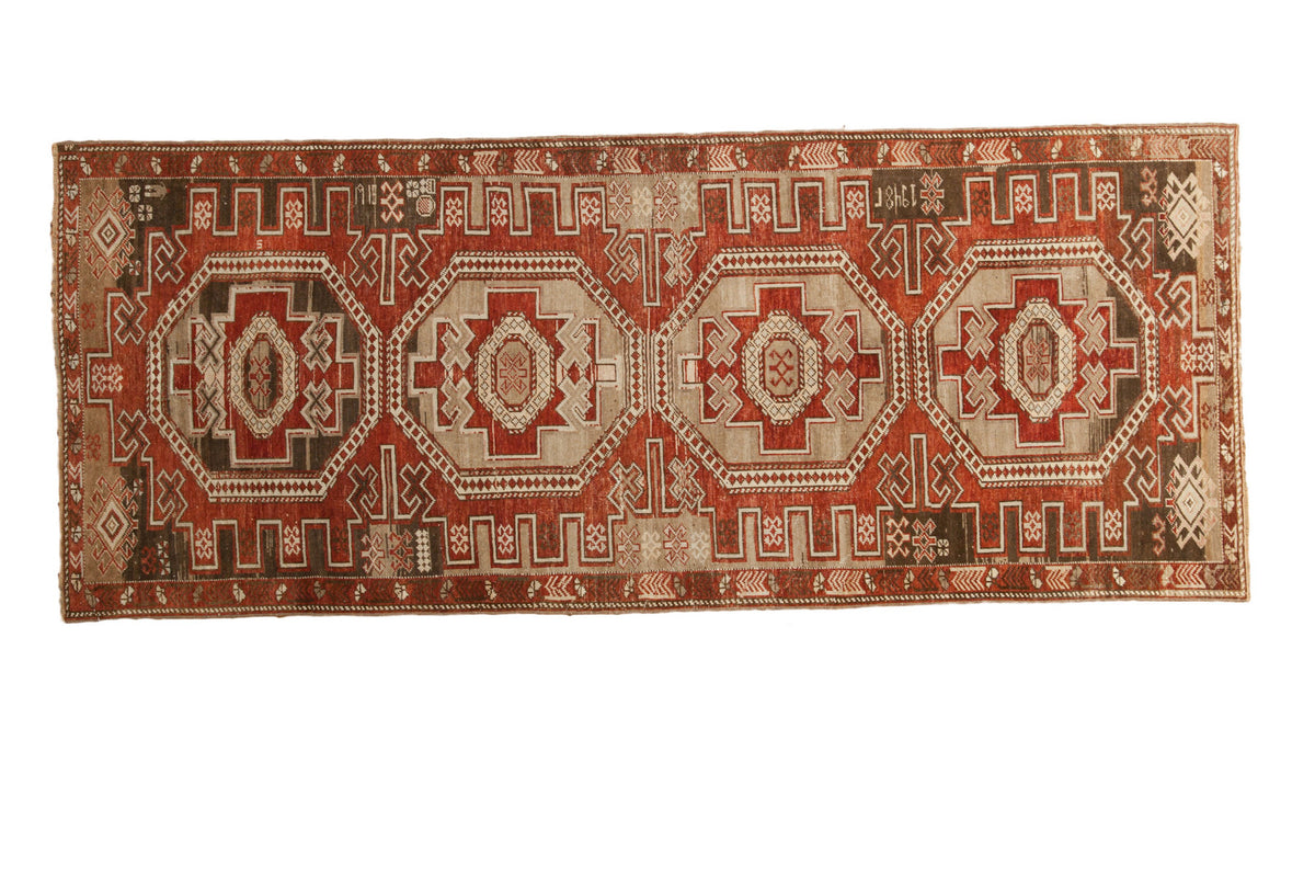 Distressed Transcaucasian runner with symmetric geometric medallions in brick red, beige, brown. 3'1"x7'9".