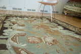 Hand-woven Turkish kilim featuring rococo-like rose and leaf pattern, earthen green and brown tones.
