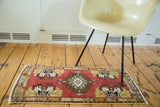 Hand-knotted cherry red Oushak rug with ivory, gold germinating planter corner motif.