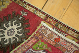 Hand-knotted vintage Oushak rug corner revealing cherry red pile, intricate reverse, and fringe.