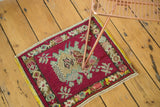 Vintage Oushak rug's cherry red field with intricate naturalistic depiction and floral border.