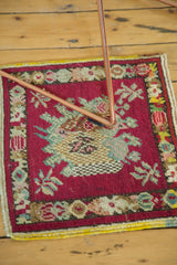 Detail of vintage Oushak rug showing cherry red field, naturalistic branches, and floral border.