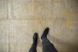 Antique Kaisary rug's distressed texture showing light gold, silver, and pale orange tones.