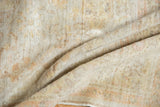 Soft pile folds of antique Kaisary rug, showing even distress and muted gold and beige.