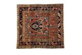 Vintage Heriz square rug: navy medallion, brick red field, floral and geometric borders, 4' x 4'2