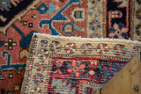 Hand-knotted Heriz rug's reverse side, sturdy fringe, and traditional motif details.