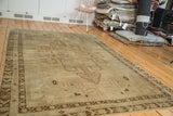 Faded bronze expressive medallion and antique ivory field of the vintage Oushak carpet.