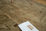 Faded Oushak carpet with soft pile and subtle patterns in bronze and antique ivory.