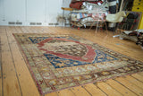Vintage distressed Oushak carpet, vibrant abrash, oversized medallion, and floral patterns.