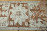 Vintage Oushak rug runner with ivory and bronze geometric star medallions.