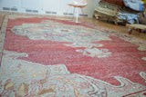 Textured crimson red distressed pile on a vintage Oushak rug with cloudband pennant.