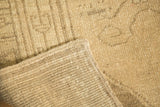 Vintage Oushak rug runner close-up of hand-knotted back, irregular weave, and secured edge.