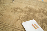 Vintage Oushak runner's irregular hand knotted weave in beige and natural wooded tones.
