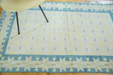 Simplistic vintage Dhurrie rug, ivory field with subtle diamond pattern, denim blue star border.
