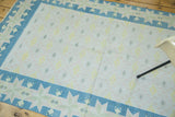 Denim blue geometric star motif border and ivory field with yellow and green patterns.