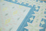 Denim blue geometric star border and field patterns on a hand woven vintage Dhurrie rug.