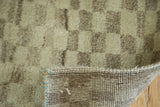 Plush faded checkered pile, hand-knotted foundation, and secure edge of a Gabbeh rug.