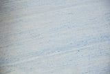 Hand woven Dhurrie carpet texture with pale powder blue and ivory minimalist design.
