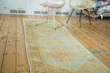 Oushak runner with stepped quadruple medallions in pastel sea foam green and light peach tones.