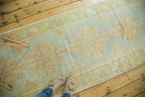 Stepped medallion design on a vintage Oushak runner, pastel green and peach tones.