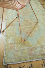 Hand-knotted Oushak runner's pastel sea foam, light peach, yellow border, and fringe.