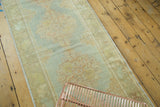 Vintage Turkish Oushak runner: pastel sea foam green with peach stepped medallion.