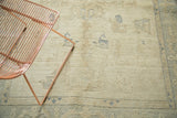 Vintage Oushak rug portion with ivory pile, scattered pale blue motifs, and light staining.