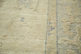 Partially carved wool pile texture in ivory and pale blue on a vintage Oushak rug.