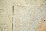 Hand-knotted foundation and ivory fringe of a vintage Turkish Oushak rug with partially carved pile.