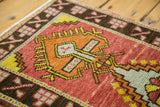 Brick red, bronze, and saffron yellow geometric Oushak medallion and border detail.