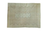 Neutral-toned distressed Oushak carpet with minimalist charcoal zigzag pattern. 5'10