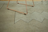 Distressed pile texture and geometric zigzag motif on a neutral vintage Oushak rug.