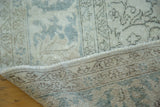 Distressed hand-knotted pile, soft texture with pale blue patterns, and woven foundation.
