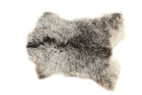 Luxurious Angora skin rug with soft ivory, grey, and charcoal wavy fur, 2'2