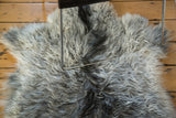 Soft, curly angora skin texture in shades of ivory, grey, and charcoal.
