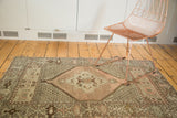 Vintage Oushak rug corner detailing geometric border and allover pattern in peach and brown.