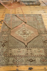 Oushak rug detail with peach, blush, and chocolate brown in repeating pattern.
