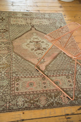 Oushak rug's central hexagonal medallion with peach, blush, and antique ivory details.