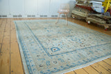 Intricate scrolling palmettes, central medallion, Tabriz rug, sand, ivory, mallard green, even distress.