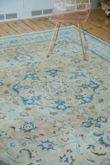 Intricate blue palmettes and scrolling tendrils on a distressed vintage Persian Tabriz carpet.