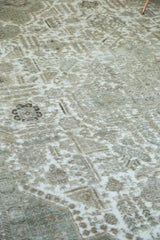 Distressed vintage Tabriz carpet detail showing exposed foundation, cotton white, charcoal tones.