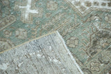 Distressed vintage Tabriz carpet with exposed foundation and visible hand-knotted backing.