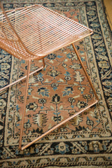 Antique Heriz rug section, peach field with geometric floral motifs and navy border.