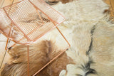 Soft angora fur texture showing ivory, silver, jet black, and reddish-brown tones.