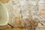 Luxurious angora skin rug in ivory and brown tones, highlighting soft texture and joined pieces.