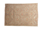Jijim carpet with geometric repeating diamonds in soft brick red and sea foam green.